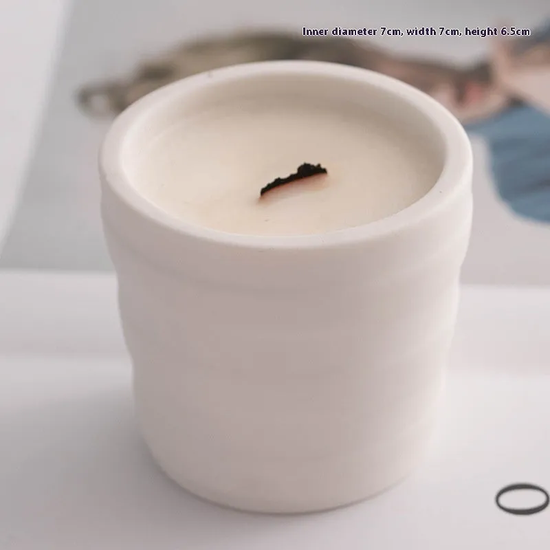 Ceramic candlestick with minimalist relief pattern on a dining table