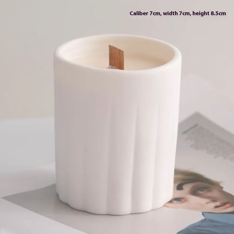 Ceramic candlestick with minimalist relief pattern on a dining table