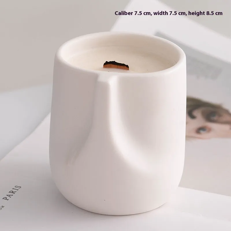 Ceramic candlestick with minimalist relief pattern on a dining table