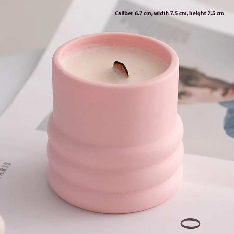 Ceramic candlestick with minimalist relief pattern on a dining table