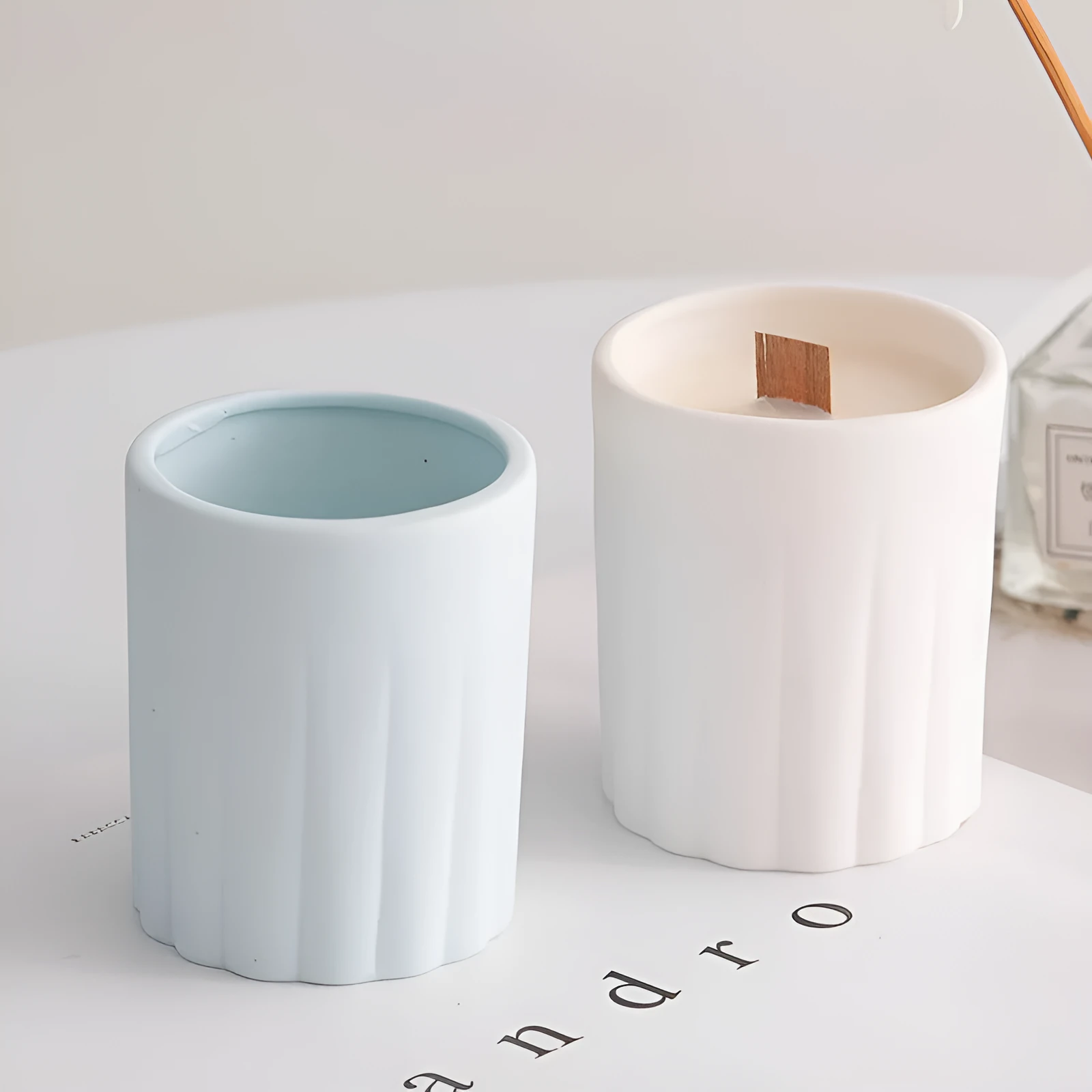 Ceramic candlestick with minimalist relief pattern on a dining table