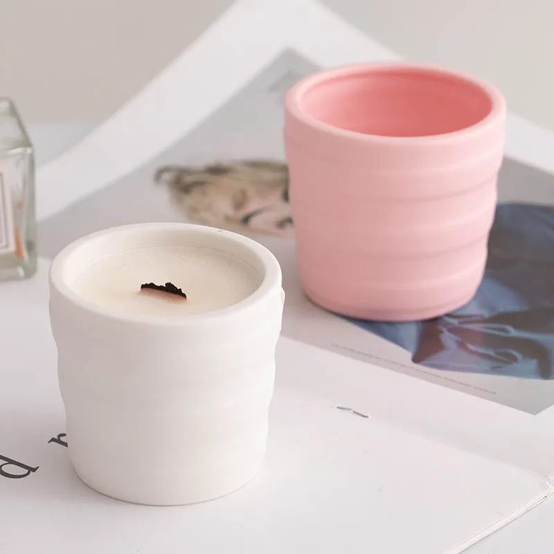 Ceramic candlestick with minimalist relief pattern on a dining table