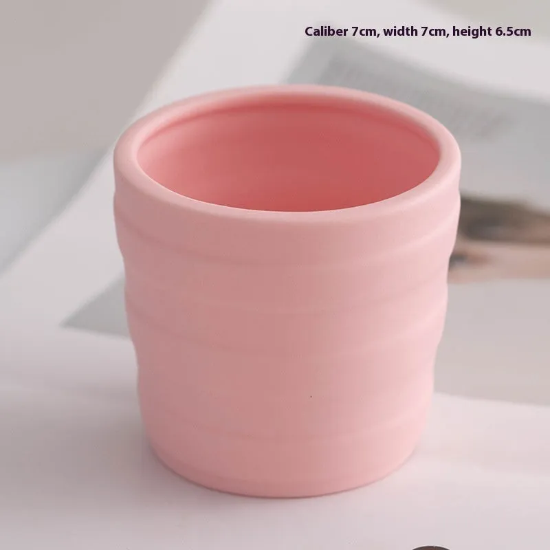 Ceramic candlestick with minimalist relief pattern on a dining table