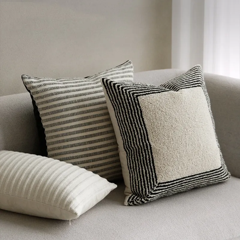 Black and white geometric patterned square and waist living room cushions with towel embroidery.