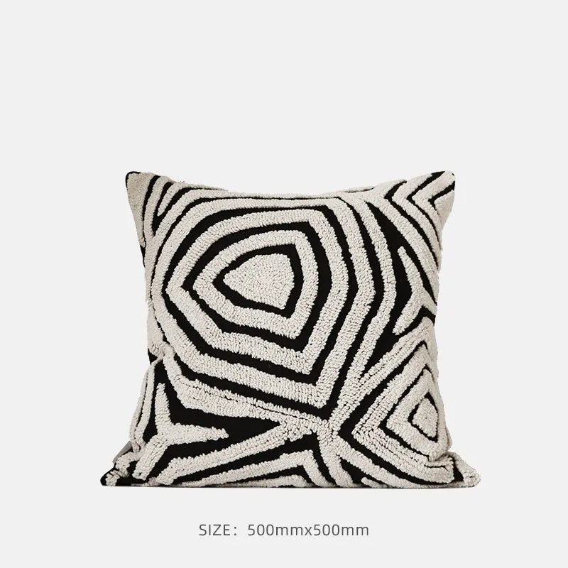 Black and white geometric patterned square and waist living room cushions with towel embroidery.