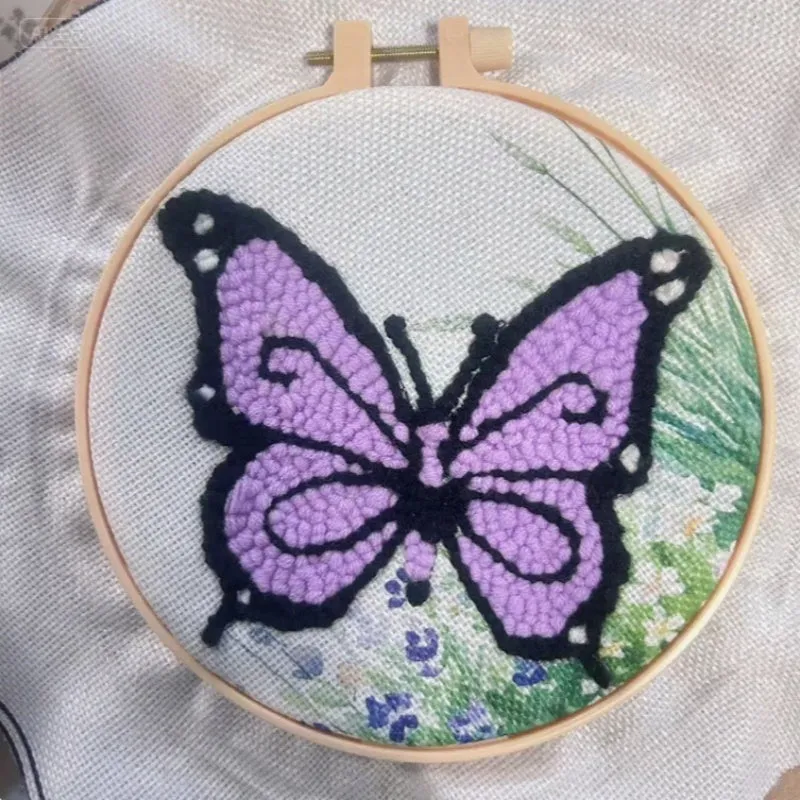 Beginner embroidery craft kit showing cartoon animal patterns including turtle, sheep, and butterfly on cloth