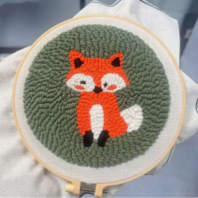 Beginner embroidery craft kit showing cartoon animal patterns including turtle, sheep, and butterfly on cloth
