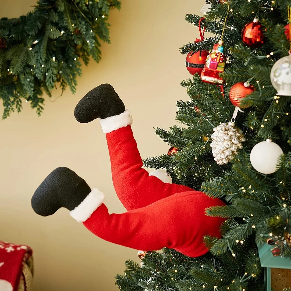 Two white fabric elf legs decorating a Christmas garden display, overall length 38cm