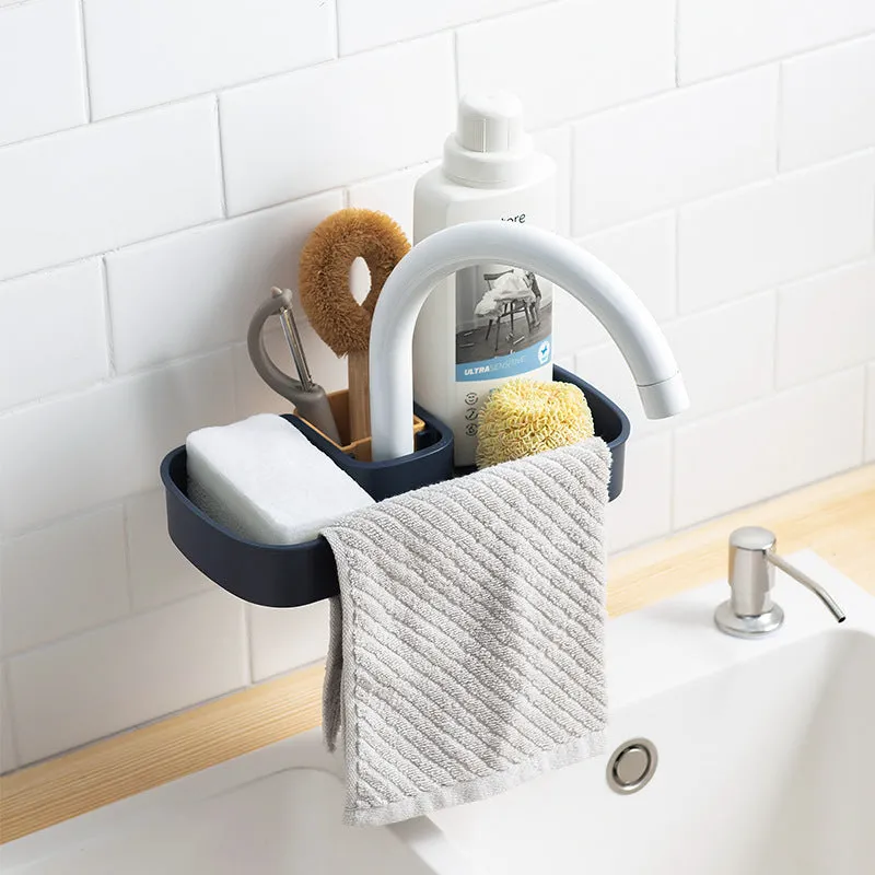 Blue sink shelf faucet holder with sponge and brush storage tray on a kitchen sink
