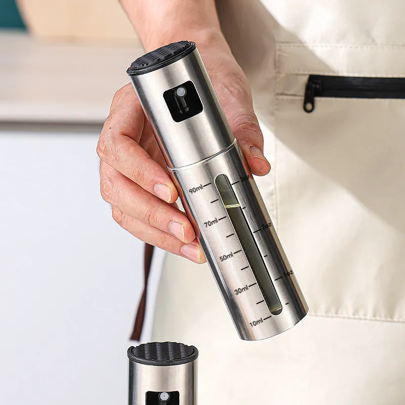 Press-type stainless steel oil spray bottle with 100ml capacity and glass body for kitchen use