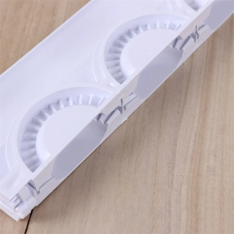Pure white ABS plastic dumpling maker on a kitchen counter, compact design, modern simple style