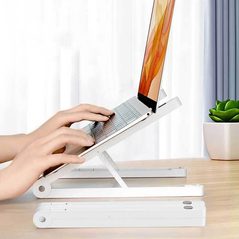 Folding plastic laptop stand desktop rack in white on a desk