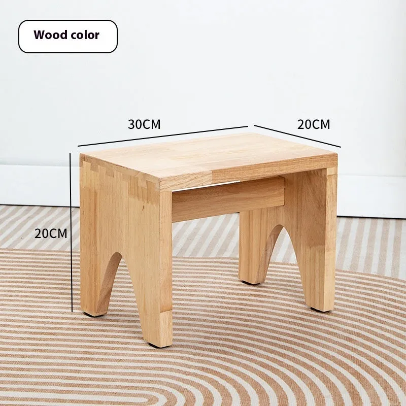 Solid wood household stool with distressed finish, shown as a changing stool or footrest.