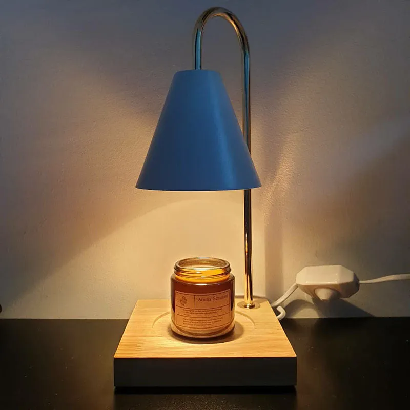White and log coloured electric candle warmer lamp with dimmer switch on desk