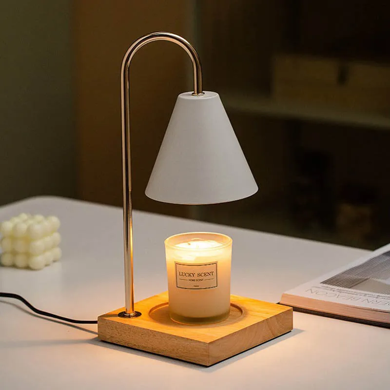 White and log coloured electric candle warmer lamp with dimmer switch on desk