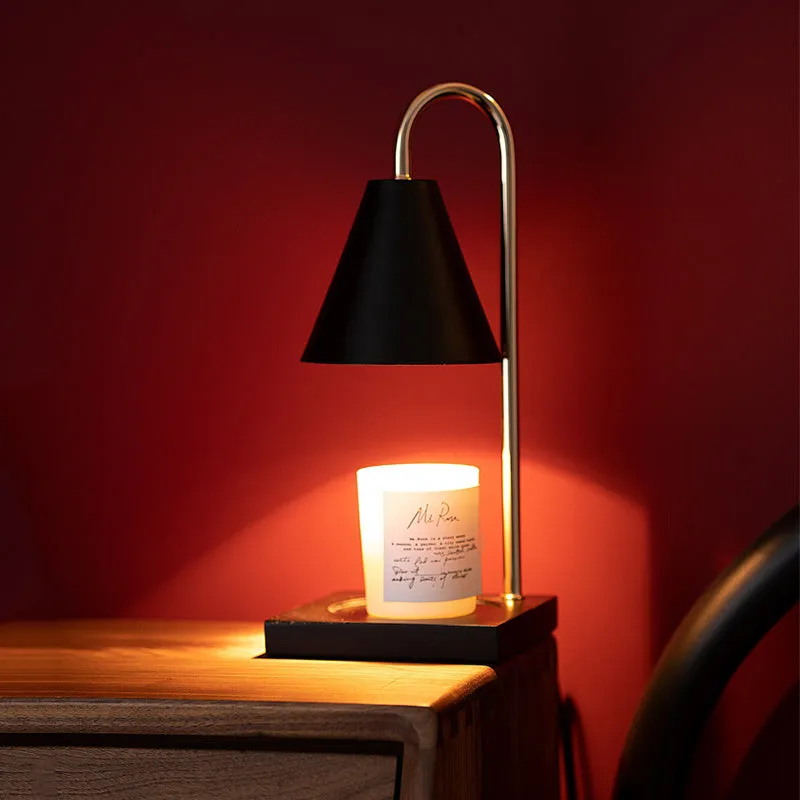 White and log coloured electric candle warmer lamp with dimmer switch on desk