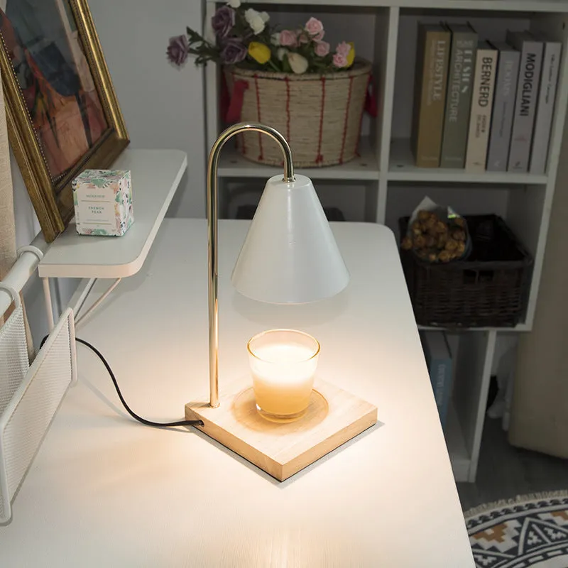 White and log coloured electric candle warmer lamp with dimmer switch on desk
