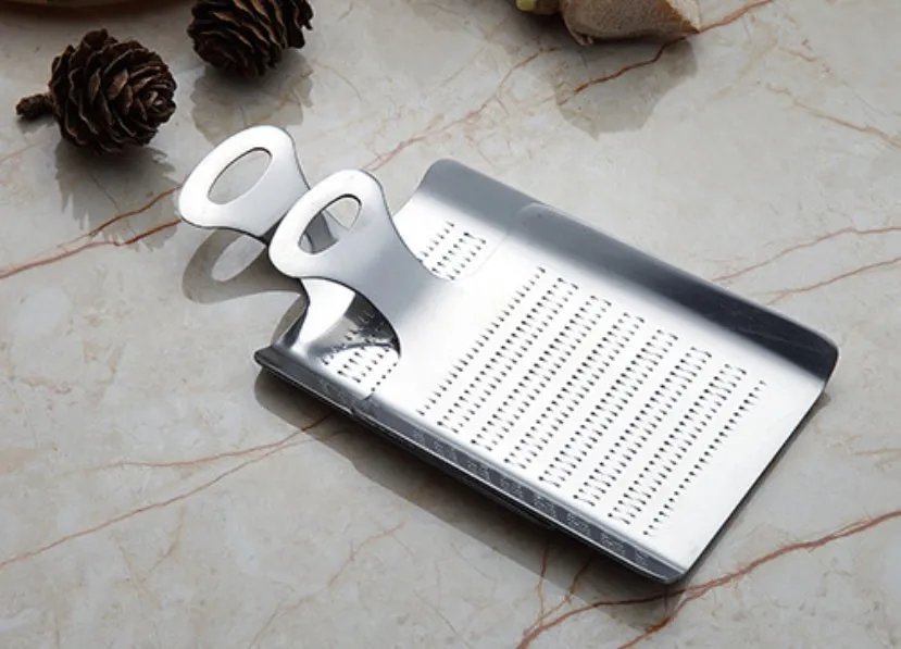Silver 304 stainless steel garlic press with ergonomic ABS handle on a kitchen counter