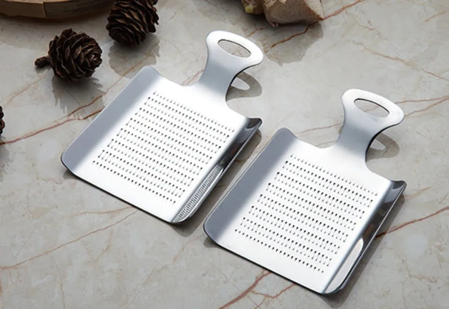 Silver 304 stainless steel garlic press with ergonomic ABS handle on a kitchen counter