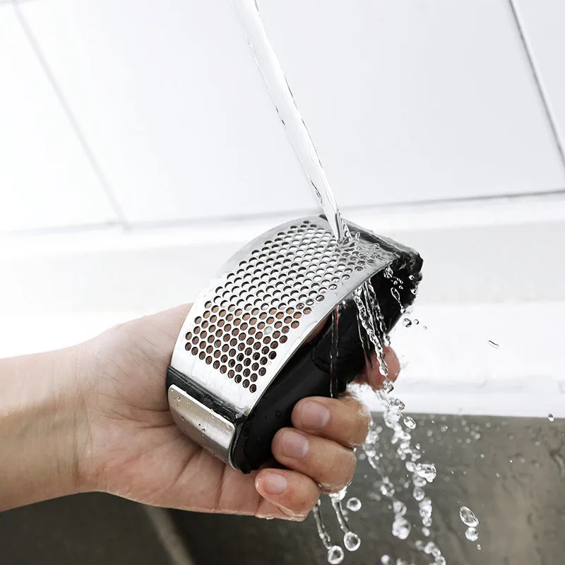 Silver 304 stainless steel garlic press with ergonomic ABS handle on a kitchen counter