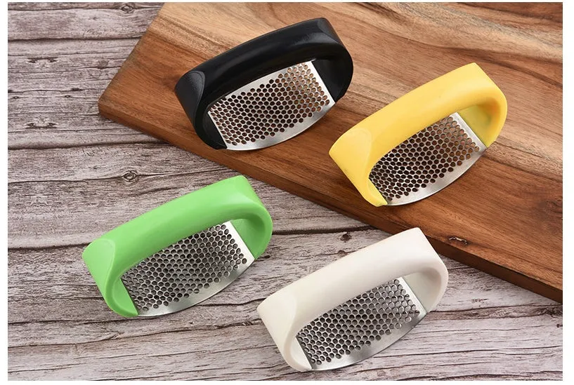 Silver 304 stainless steel garlic press with ergonomic ABS handle on a kitchen counter