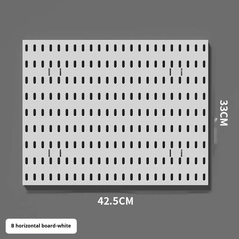 White punch-free plastic cable organisation board mounted on a wall with wires neatly wrapped.