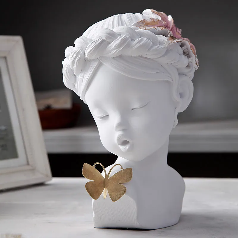 Nordic style resin character figurine in light blue and white on a desktop