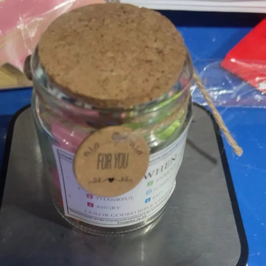 Glass Bible verses jar with cartoon style containing 90 scripture slips on a table