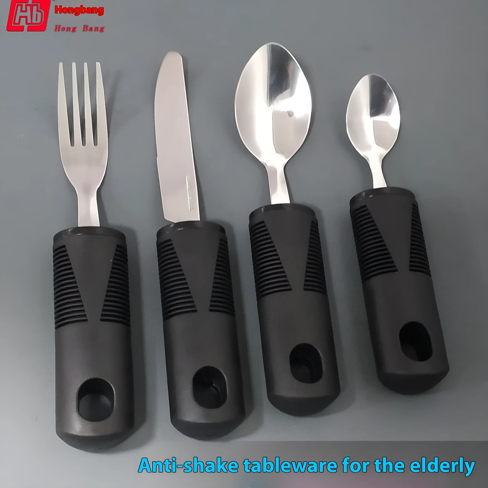 Stainless steel adaptive cutlery set with black rubber handles, showing knife, fork, and spoon.