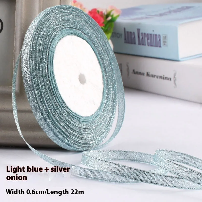 Roll of narrow 0.6cm wide polyester gift ribbon in a multicolour pattern.