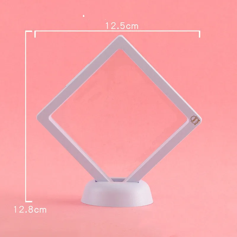 3D floating display case holding coins and jewellery between transparent membrane sheets
