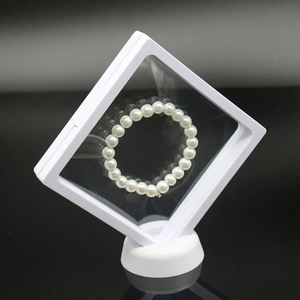 3D floating display case holding coins and jewellery between transparent membrane sheets