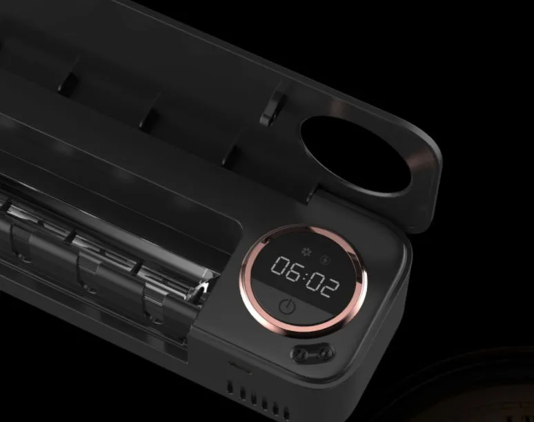 UV toothbrush holder steriliser with LED display attached to wall, showing countdown, black colour