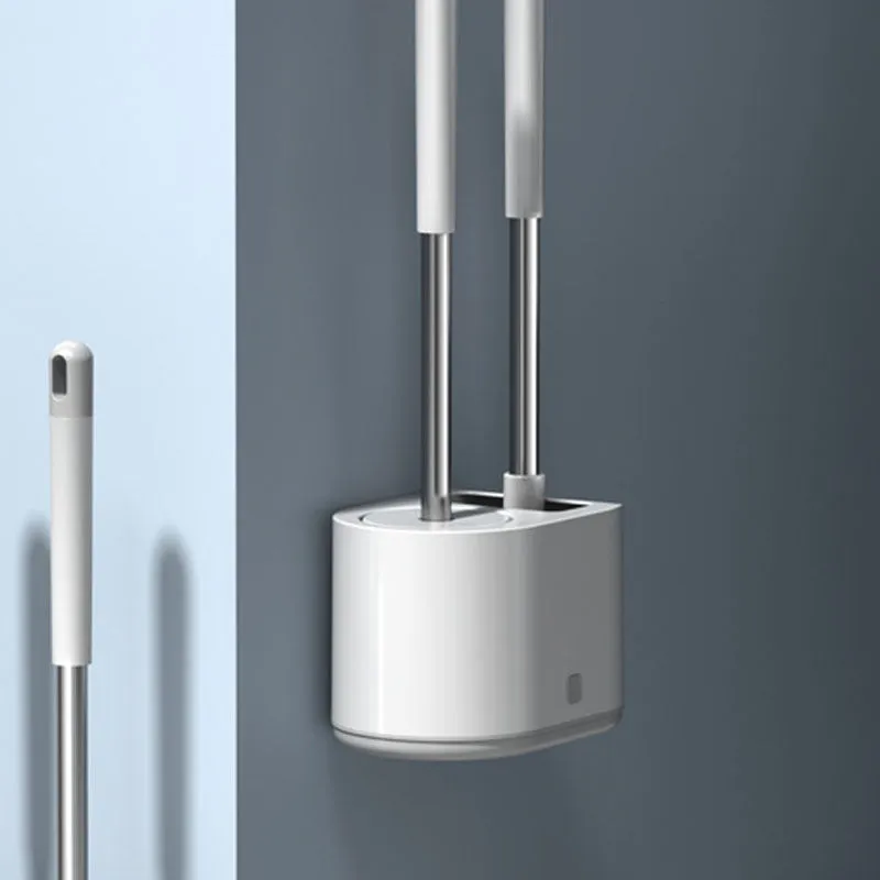White silicone toilet brush set with long handle, soft TPR head, and second cleaning brush on a bathroom floor
