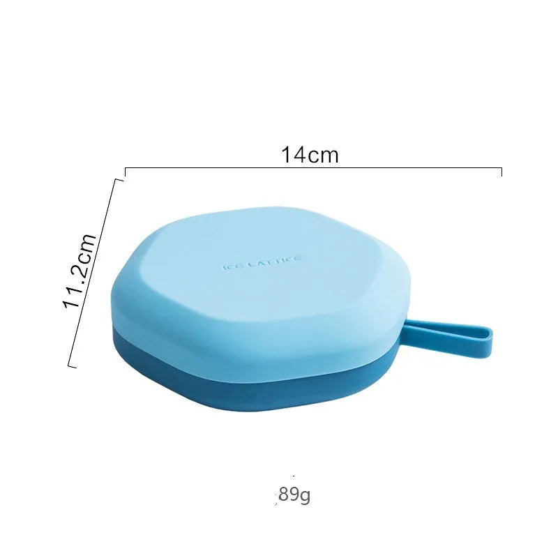 Silicone 12 cavity hexagon ice cube tray with silicone cover in blue, on a countertop