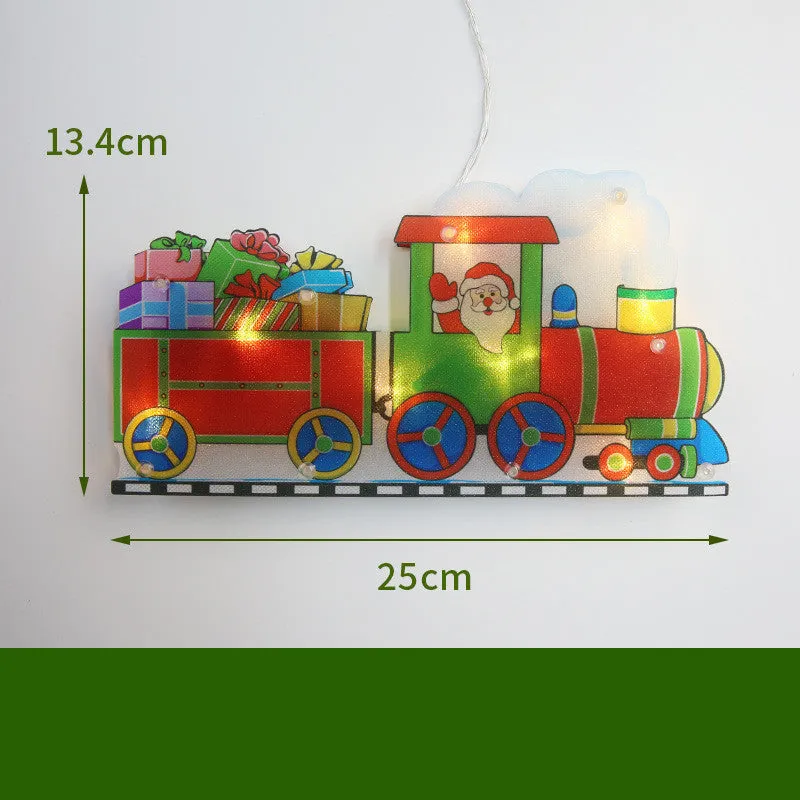 Set of 8 PVC LED Christmas decoration figures including Santa, snowman, reindeer, Christmas tree, train, and more on a windowsill