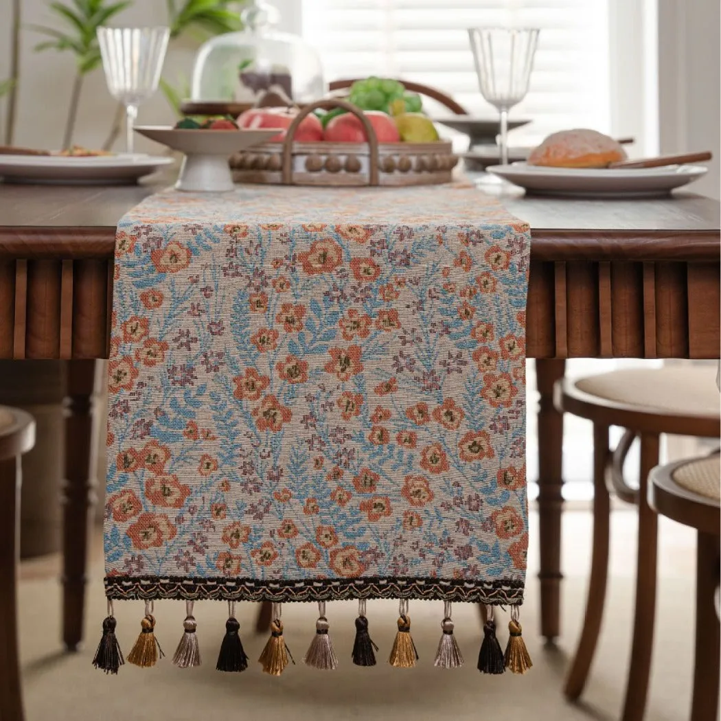 American-style beige jacquard table runner with long tassels and floral pattern on a dining table.