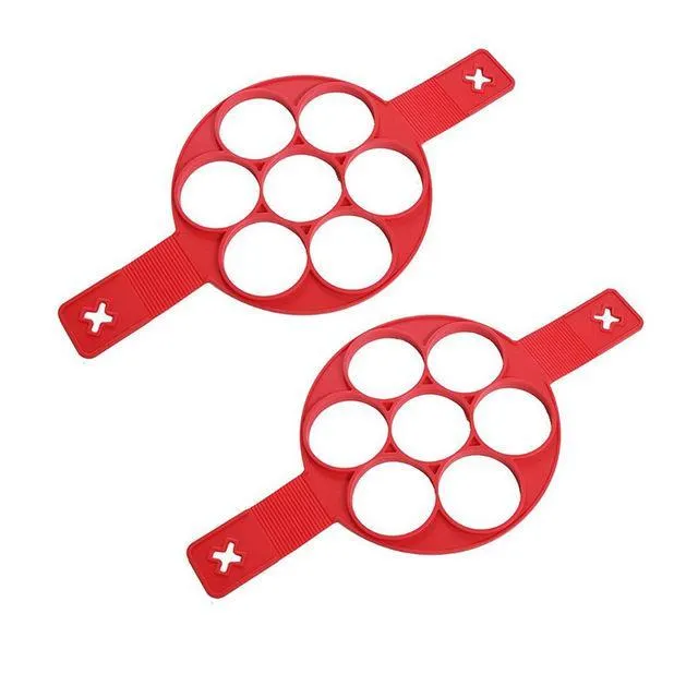 Red silicone nonstick egg pancake maker ring laid flat on a cooking surface