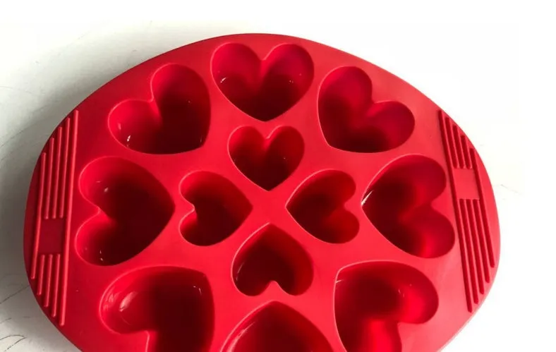 Red silicone nonstick egg pancake maker ring laid flat on a cooking surface
