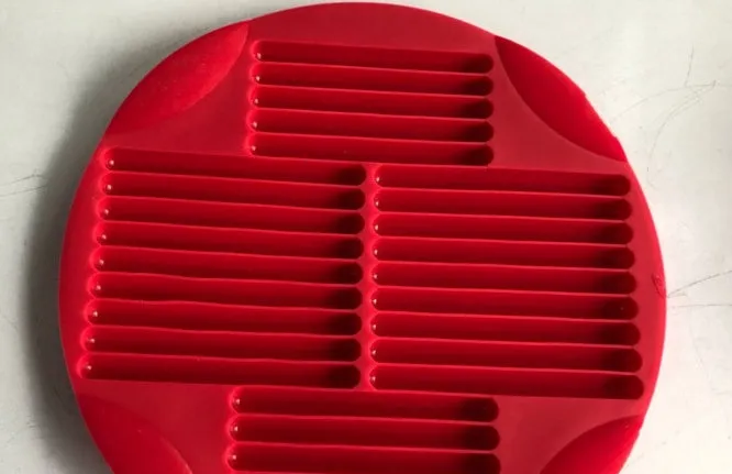 Red silicone nonstick egg pancake maker ring laid flat on a cooking surface