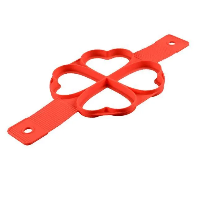 Red silicone nonstick egg pancake maker ring laid flat on a cooking surface