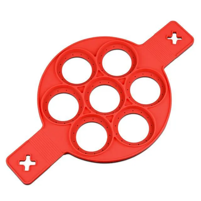 Red silicone nonstick egg pancake maker ring laid flat on a cooking surface