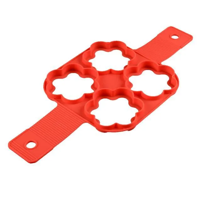Red silicone nonstick egg pancake maker ring laid flat on a cooking surface