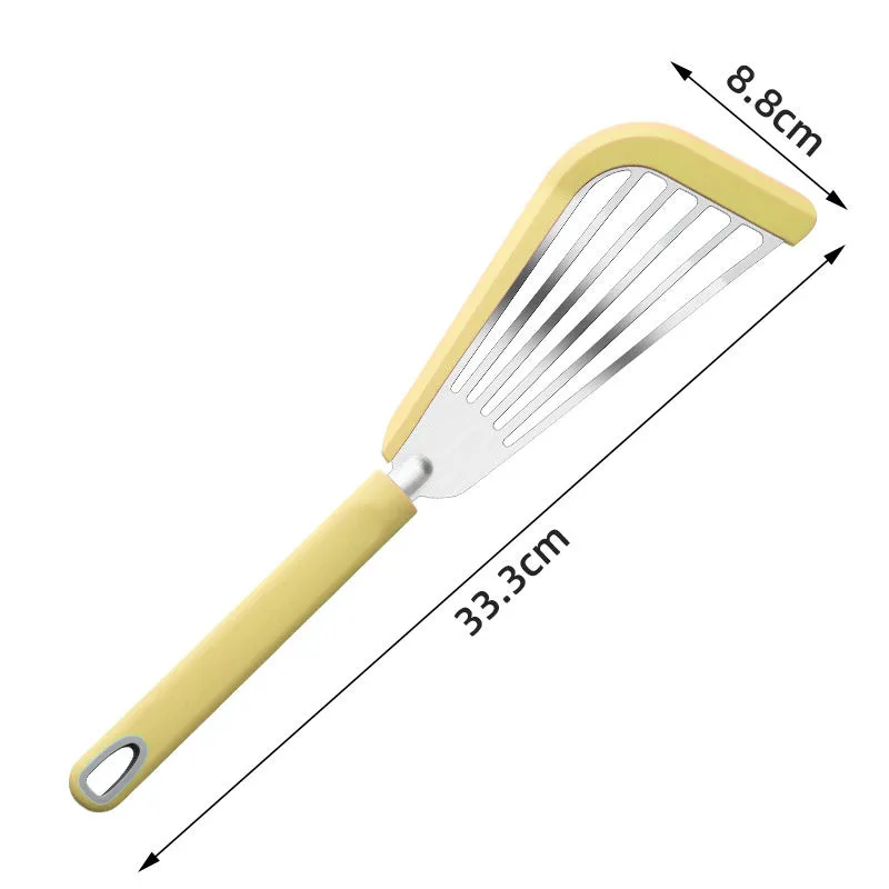 Green silicone fish spatula with 1mm thin slotter blade and hanging hole on a kitchen counter