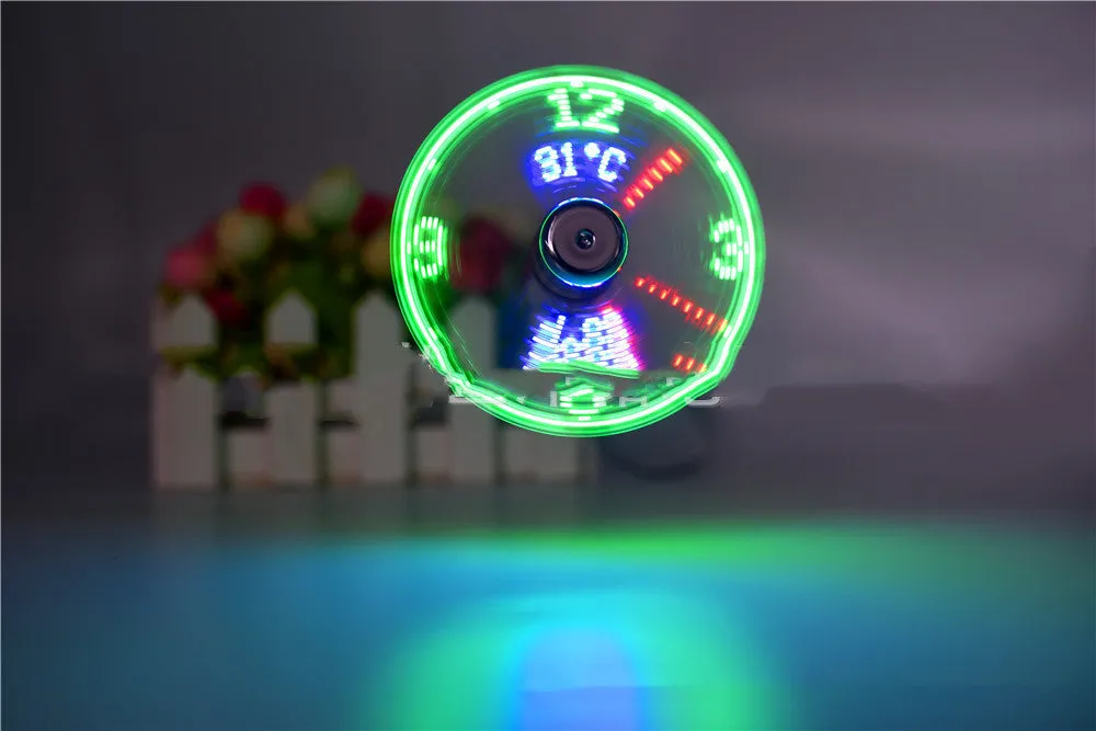 USB clock temperature fan with LED display, soft plastic blades, and flexible silver metal neck on a desk