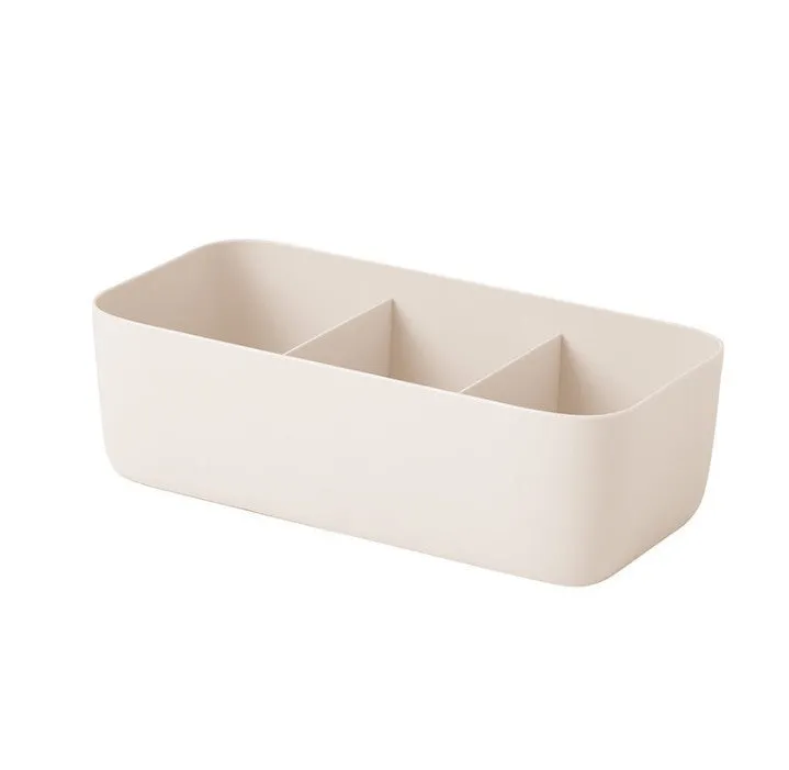 PP plastic socks and underwear storage box with grid compartments in apricot colour on a desktop