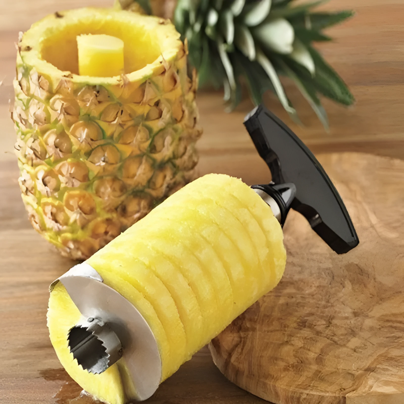Stainless steel pineapple peeler with ergonomic handle and sawtooth blade on a countertop