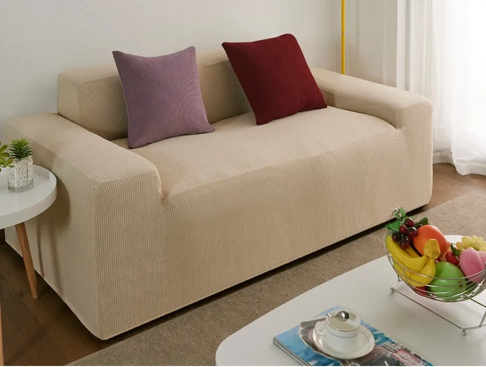 Waterproof polar fleece solid colour sofa slipcover with elastic bottom fitted on a 3-seat sofa in beige colour