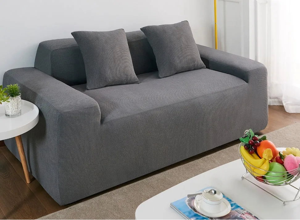 Waterproof polar fleece solid colour sofa slipcover with elastic bottom fitted on a 3-seat sofa in beige colour