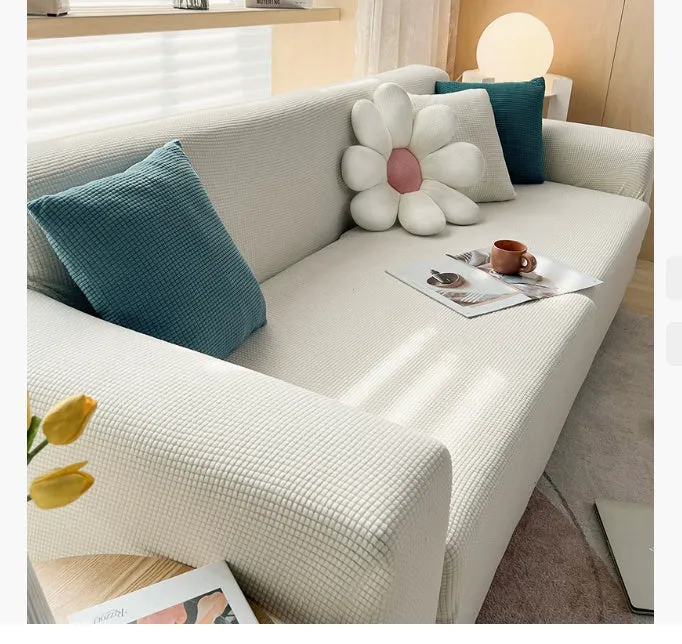 Waterproof polar fleece solid colour sofa slipcover with elastic bottom fitted on a 3-seat sofa in beige colour